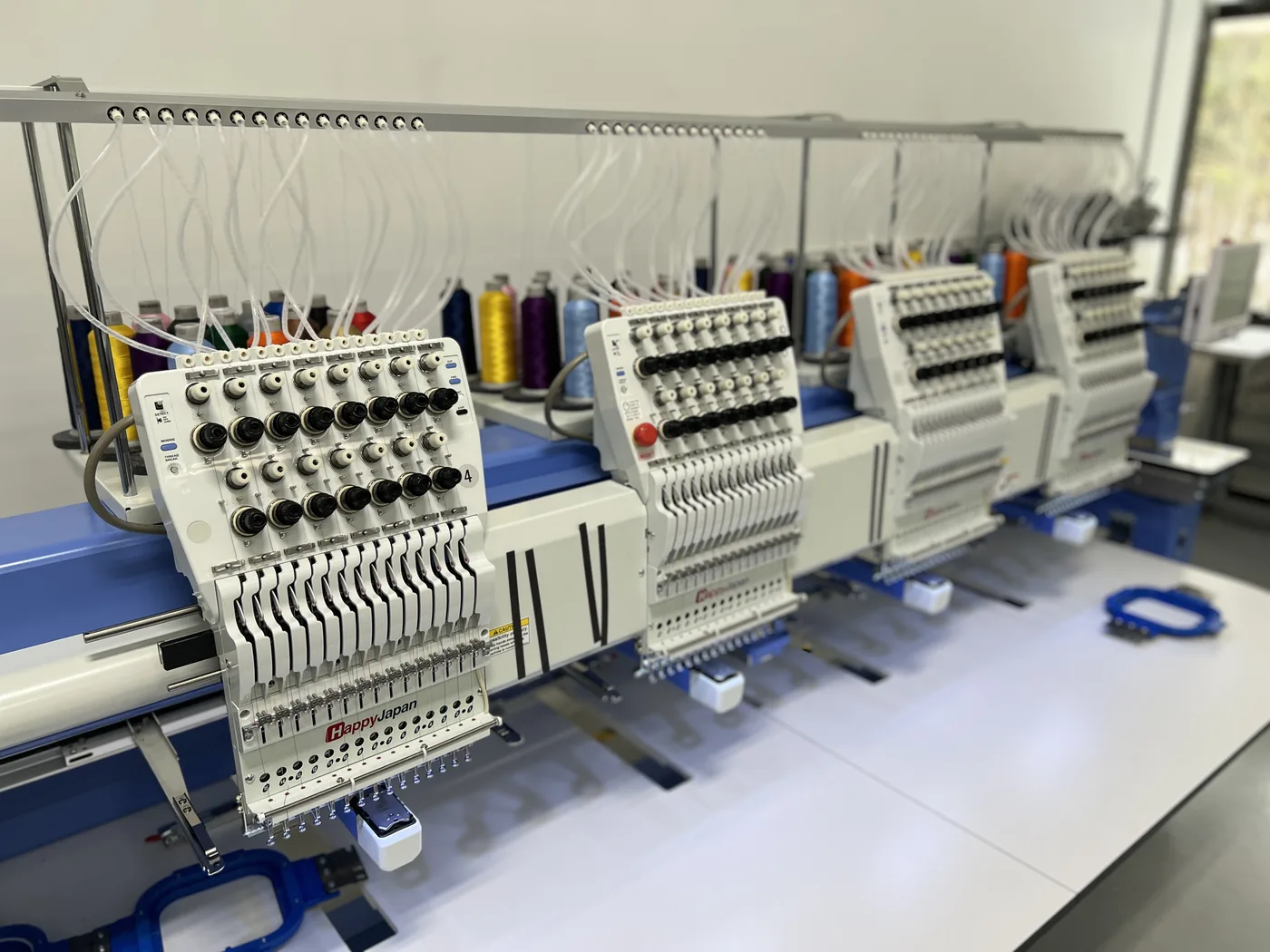 Multi-head embroidery machines at the FLO shop in Holliston, MA