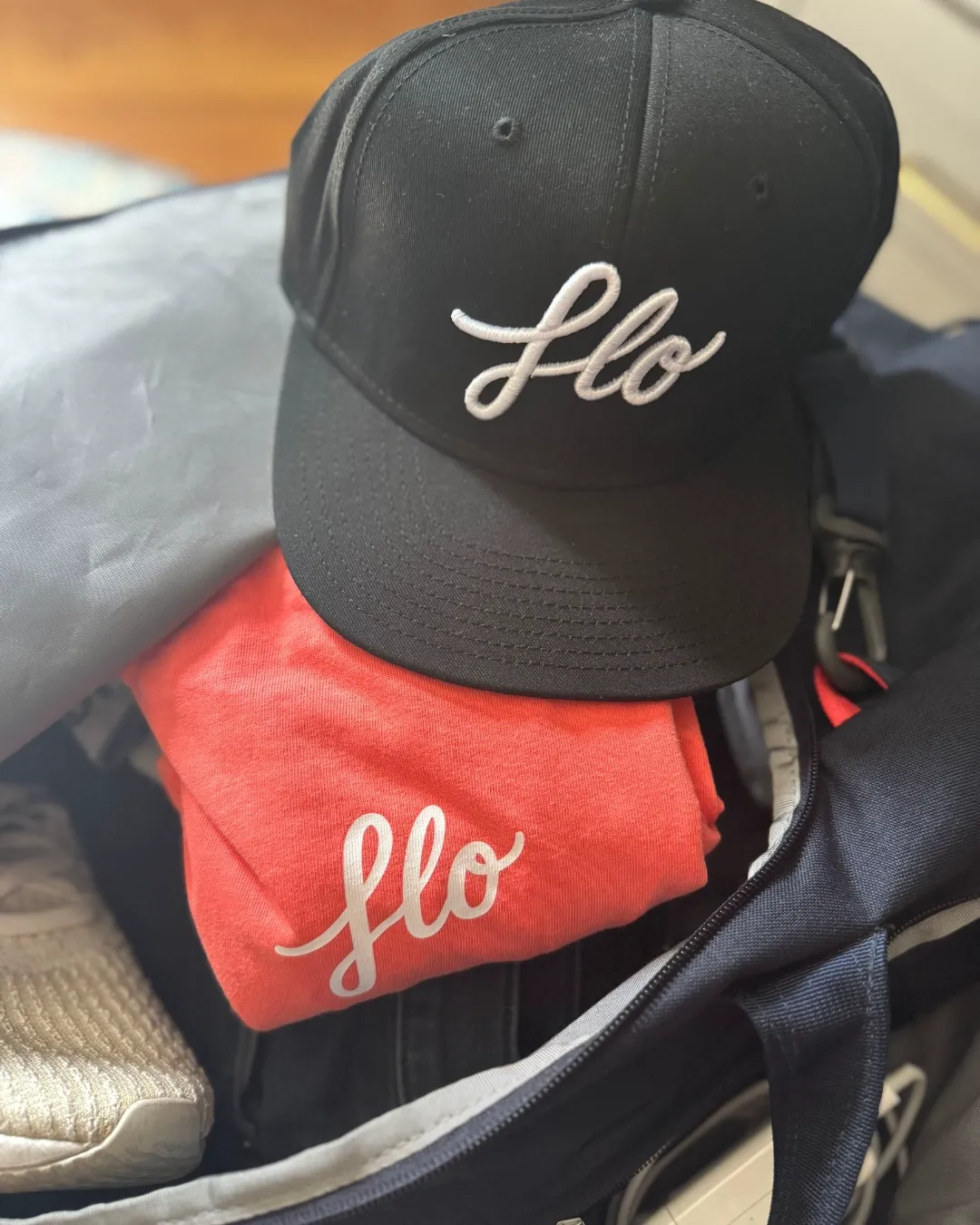 Embroidered hat and heat-pressed t-shirt made by FLO