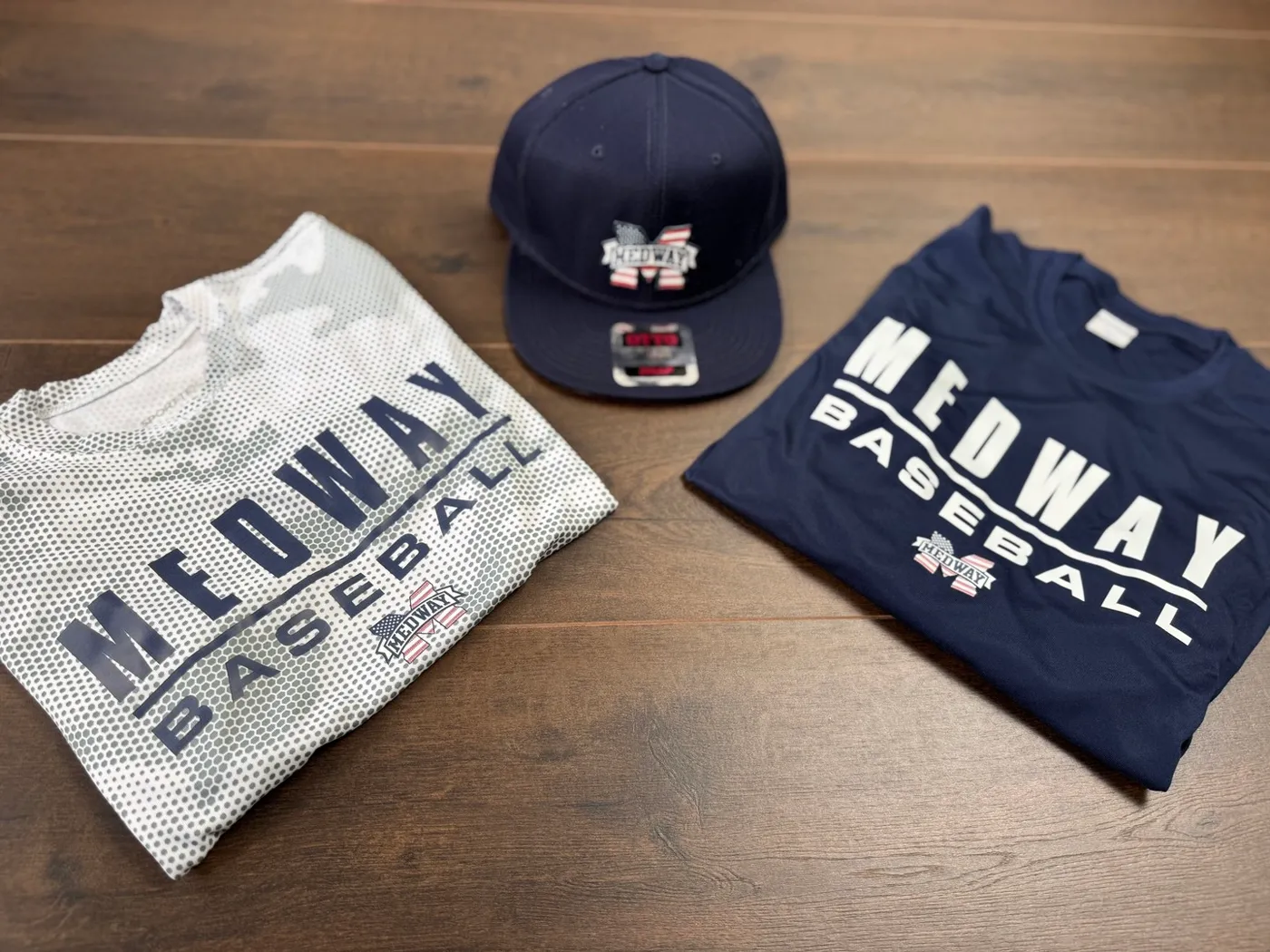 Custom embroidered hats and shirts made for Medway Baseball