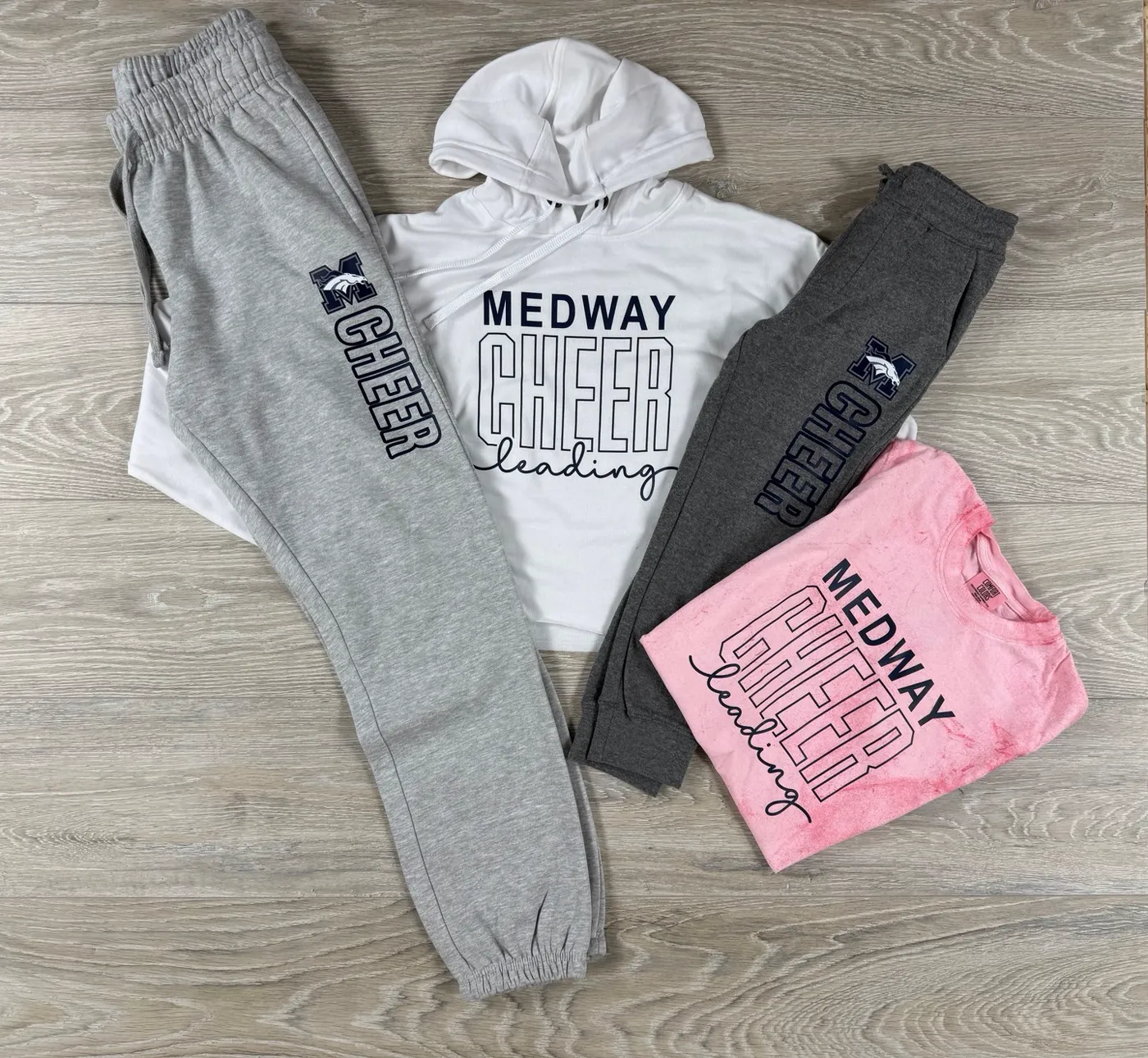 Custom Medway Cheerleading sweatpants, hoodies, and tees made by FLO